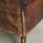 Vintage sheepskin wingback armchair in a deep brown colour finished