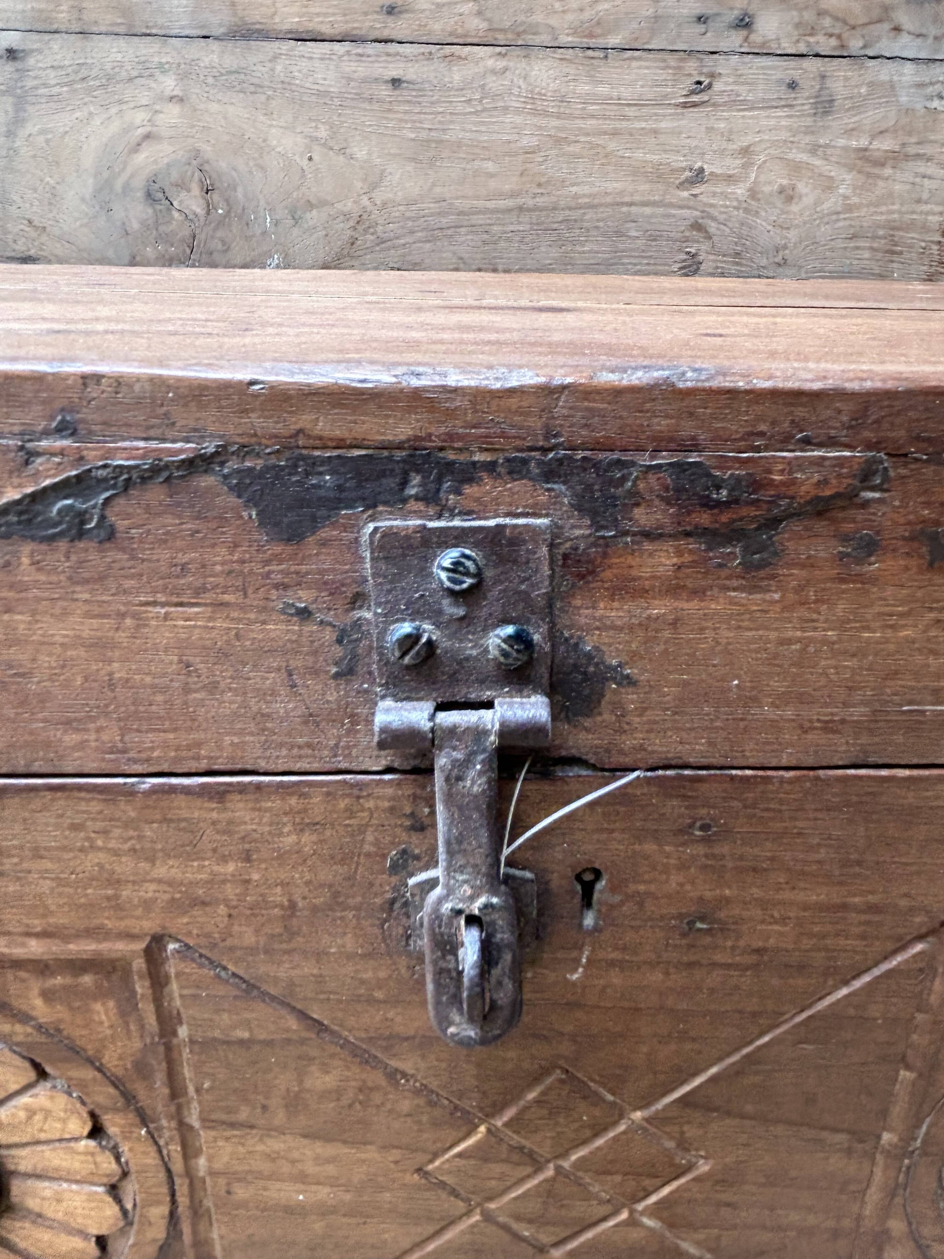 Teak chest from Burma with carved rosettes.