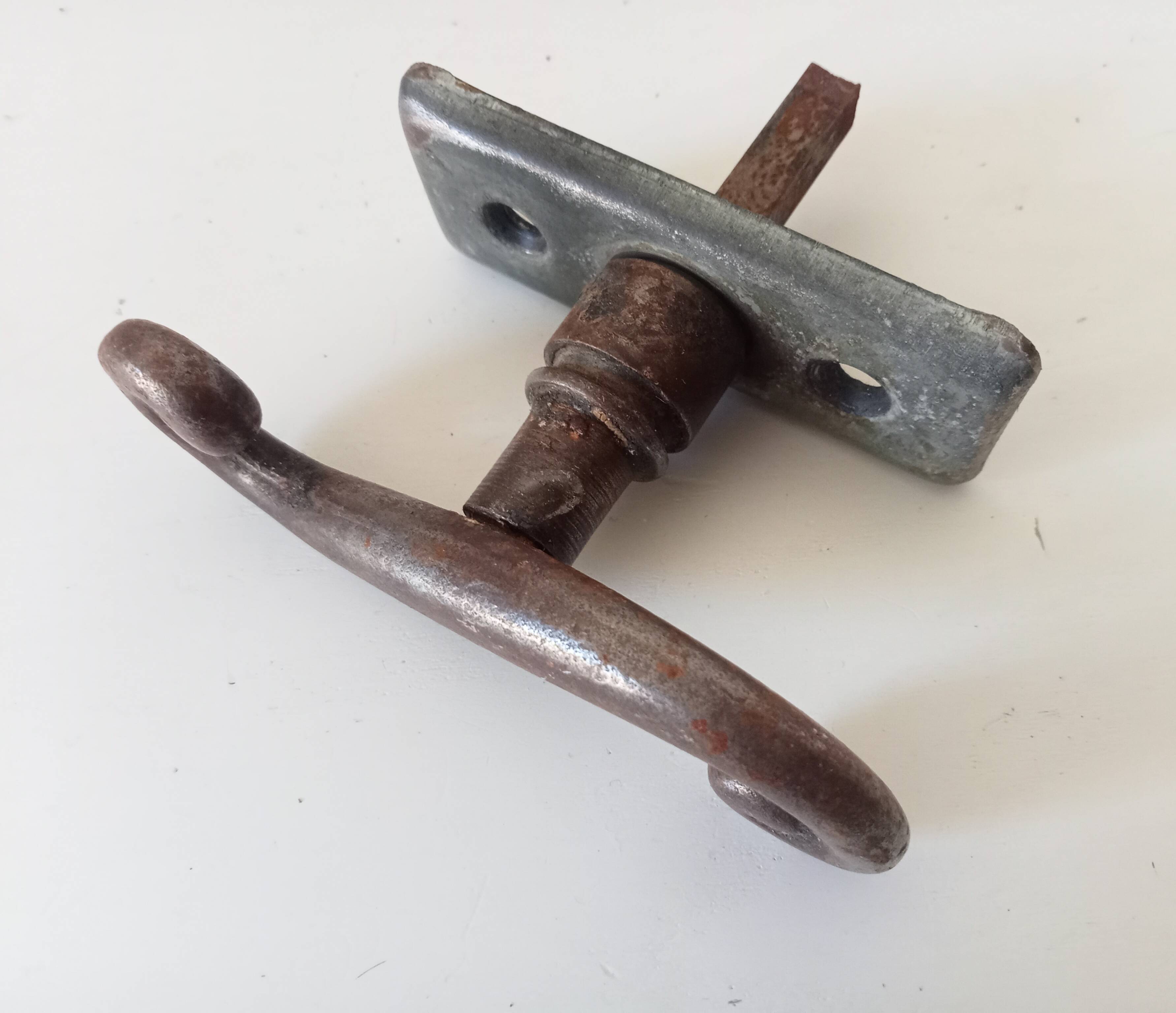 Old window handle with a forged iron cremon.