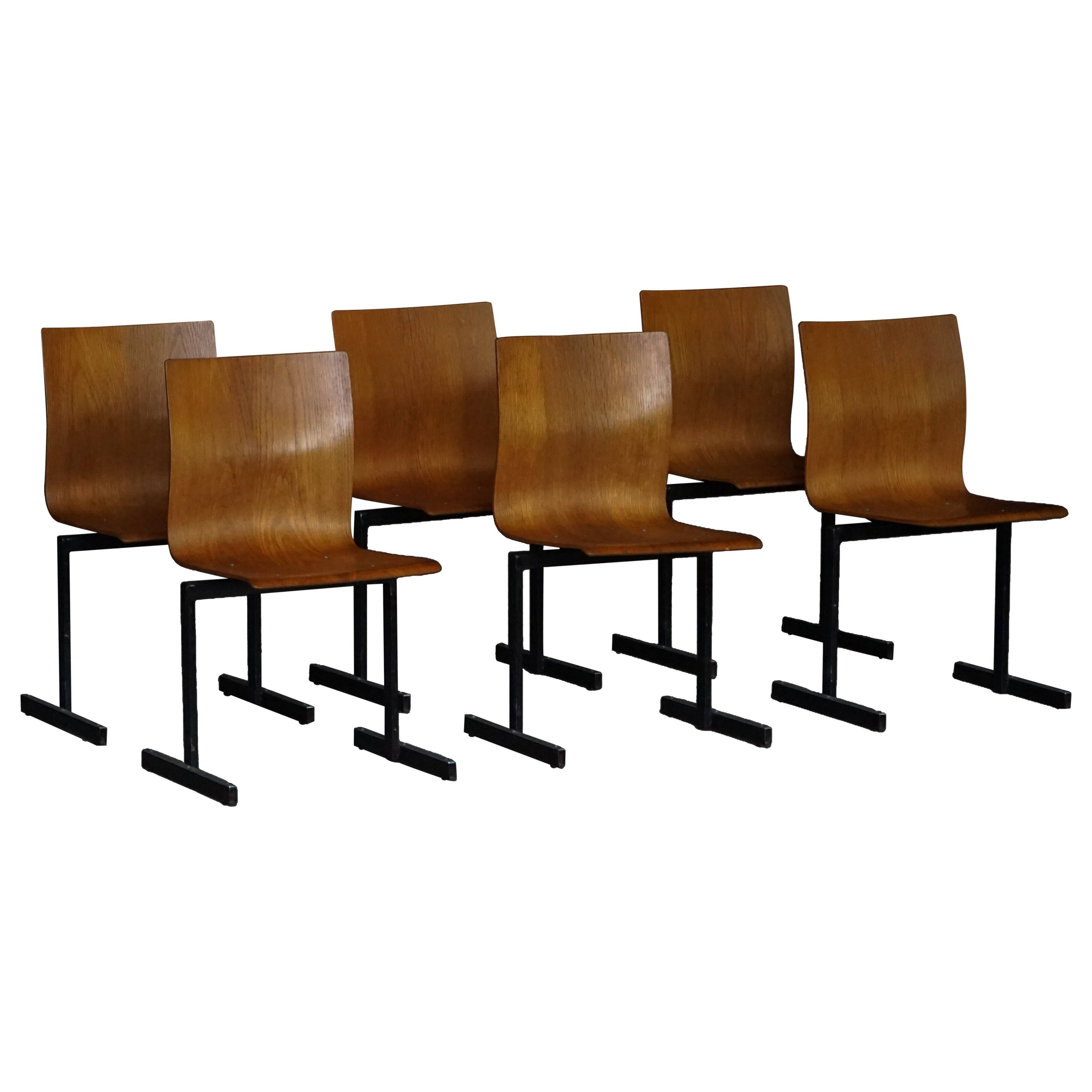 Set of 6 industrial stackable chairs by Niels Larsen, black metal and oak, 1960s.