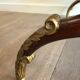 Coffee table in patinated and gilded carved wood with mirror top