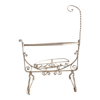 Old wrought iron cradle painted