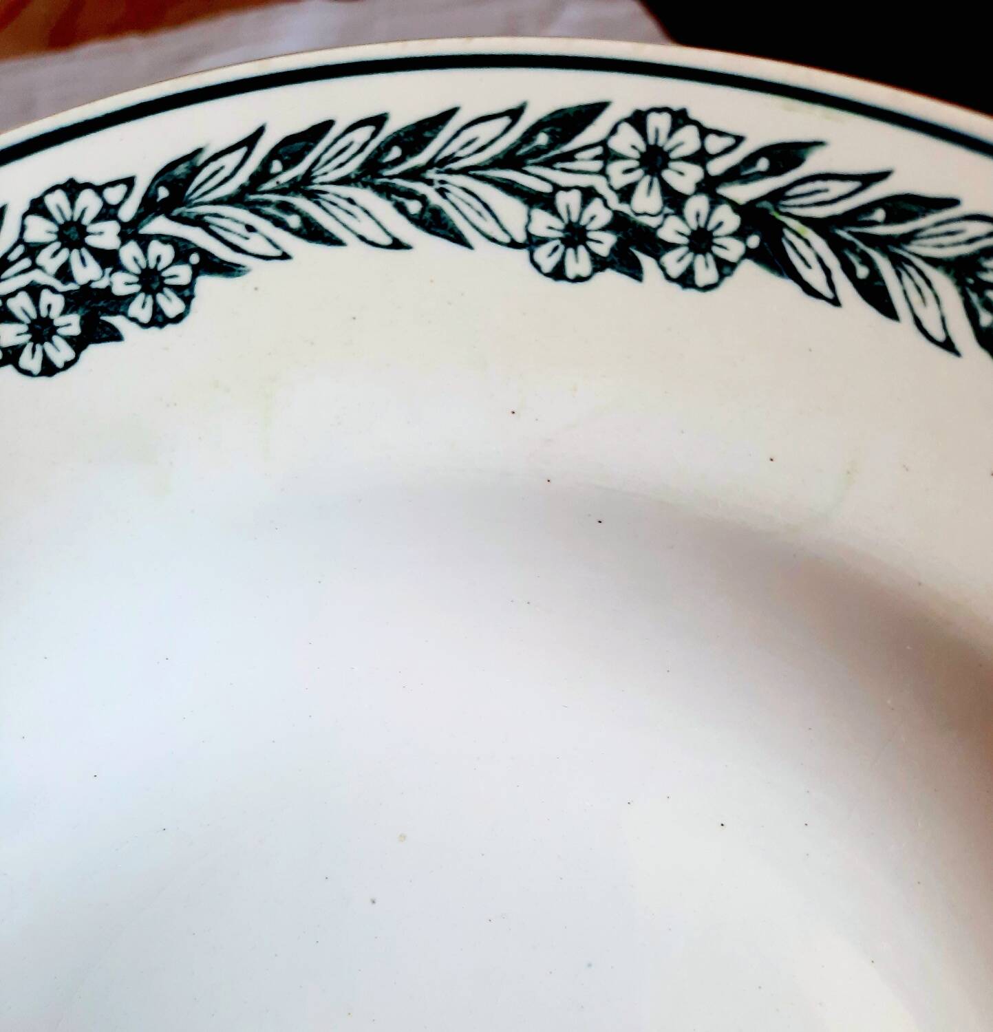 Old mismatched hollow plates in iron earth earthenware accompanied by a soup tureen