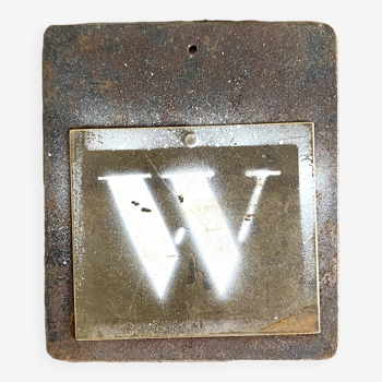Metal letter W on plaque