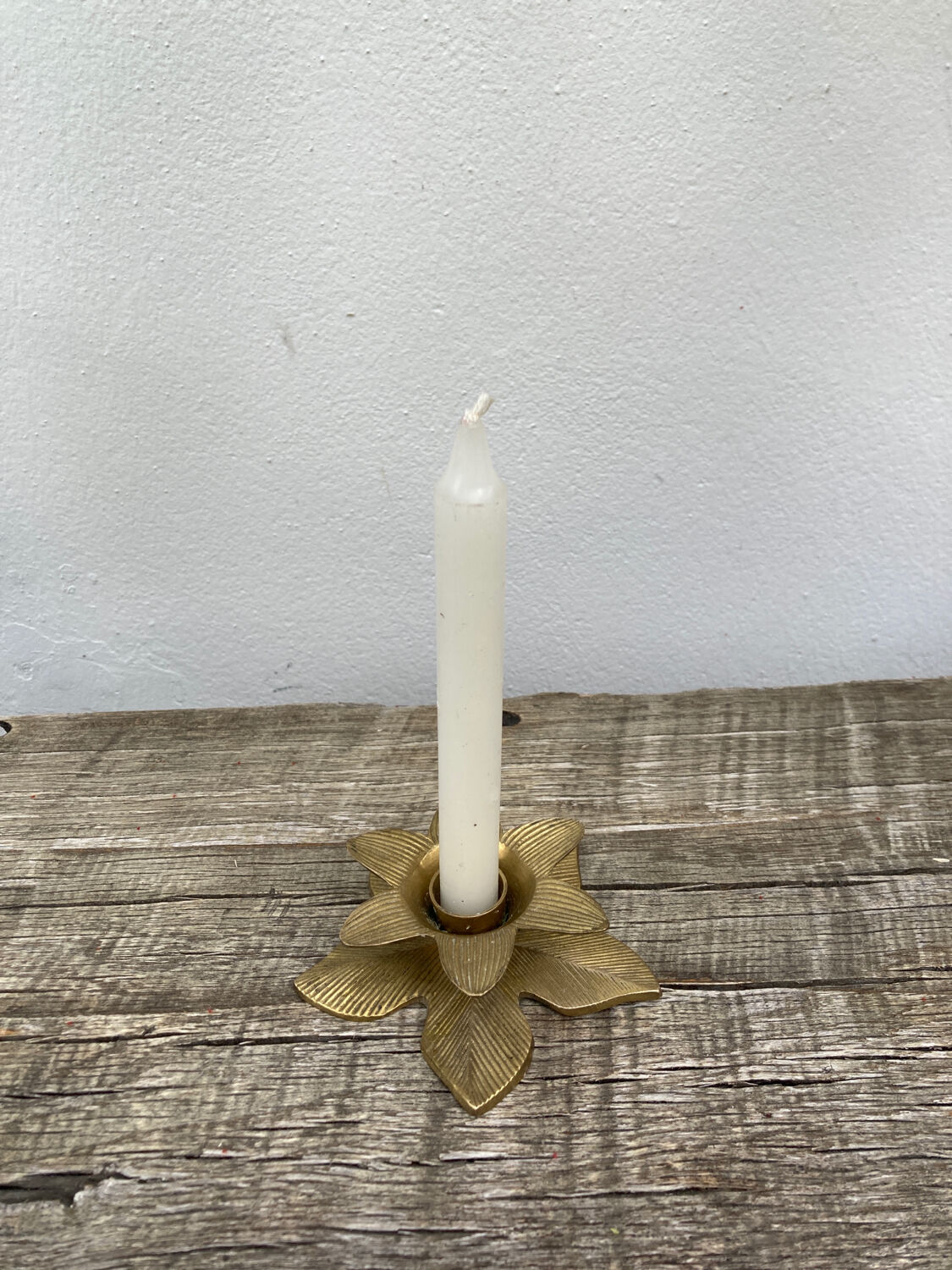 Old golden brass candle holder in the shape of a leaf or flower
