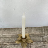 Old golden brass candle holder in the shape of a leaf or flower