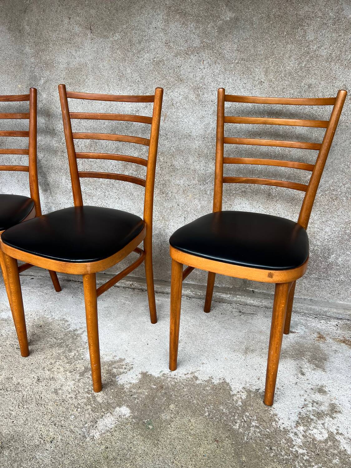 Set of 4 vintage wooden chairs with faux leather.