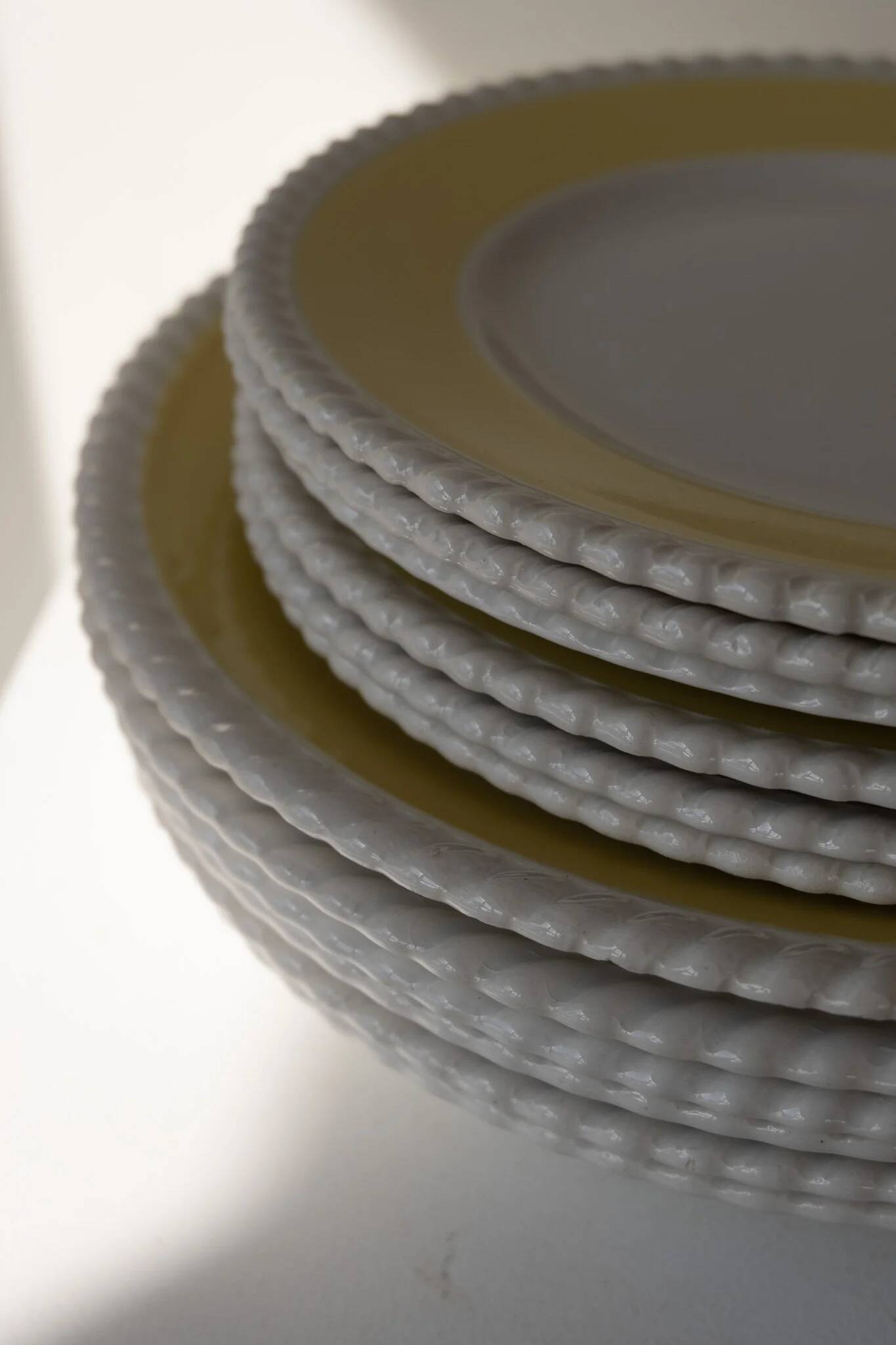 Vintage yellow butter ceramic dinnerware set with swirl border.