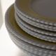 Vintage yellow butter ceramic dinnerware set with swirl border.
