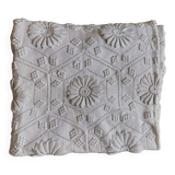 White bed throw with relief embroidery and floral patterns
