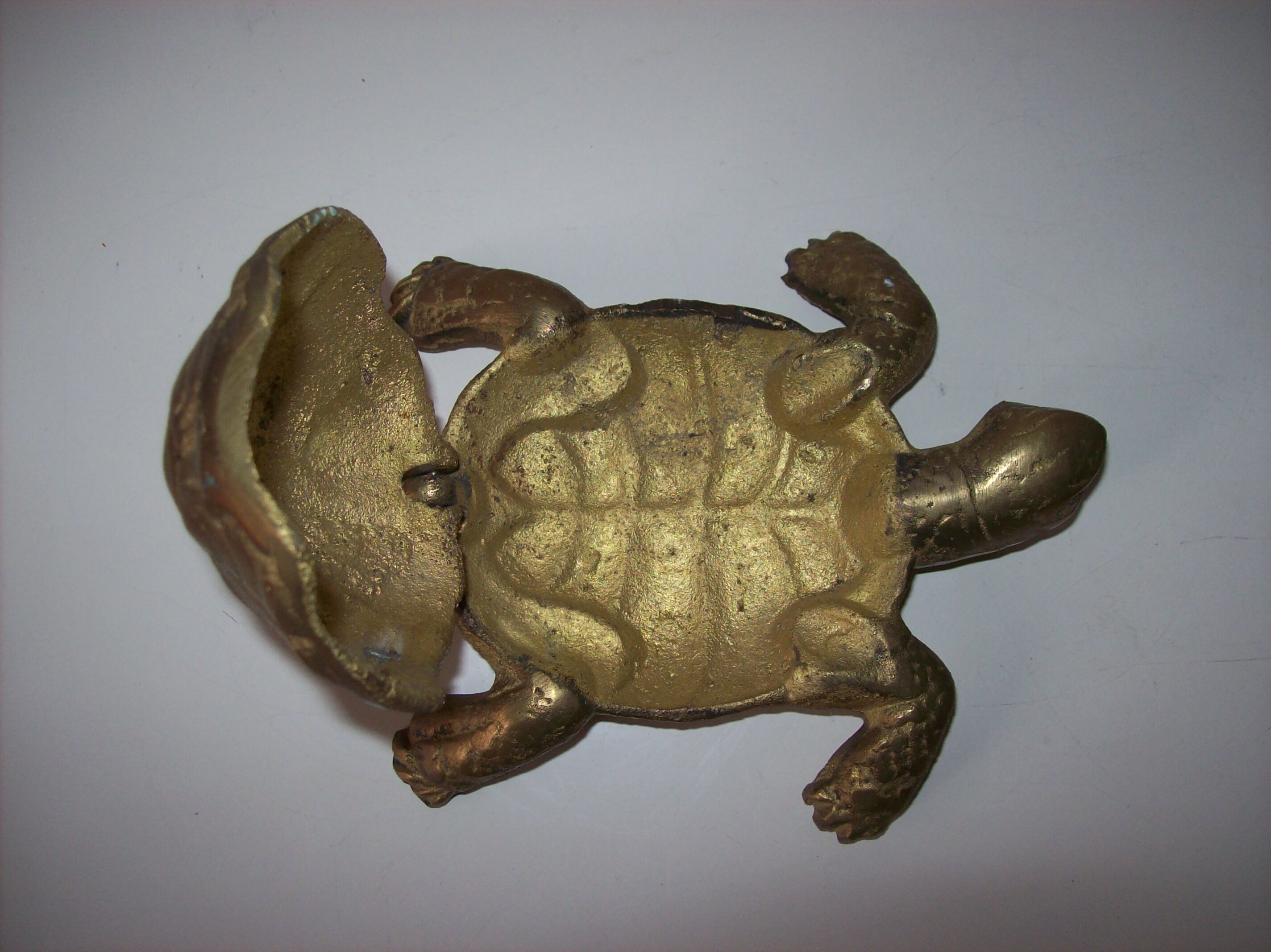 Golden brass ashtray has a turtle-shaped