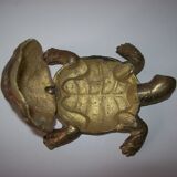 Golden brass ashtray has a turtle-shaped