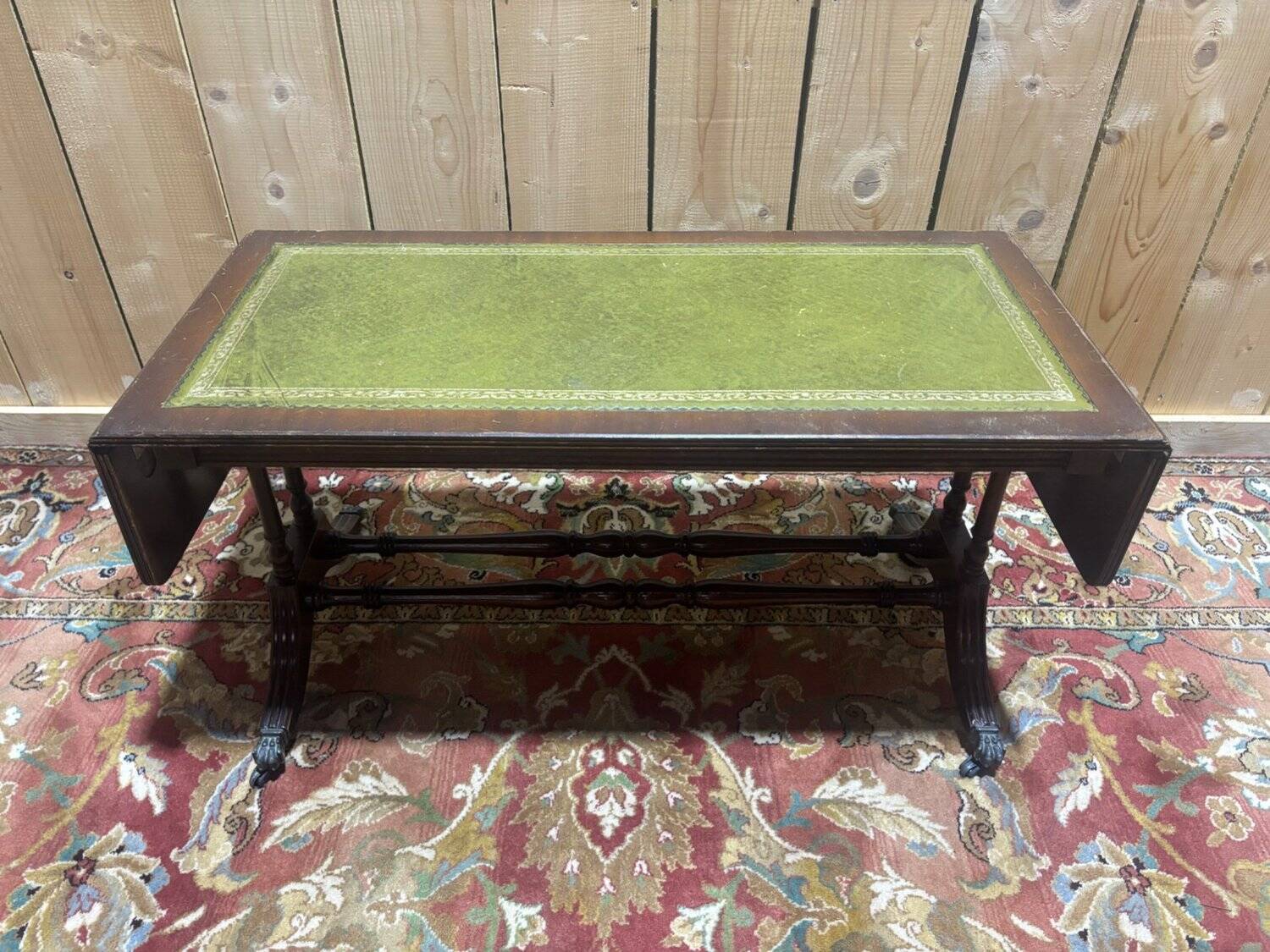 English Regency coffee table, mahogany & green stamped leather with gold.