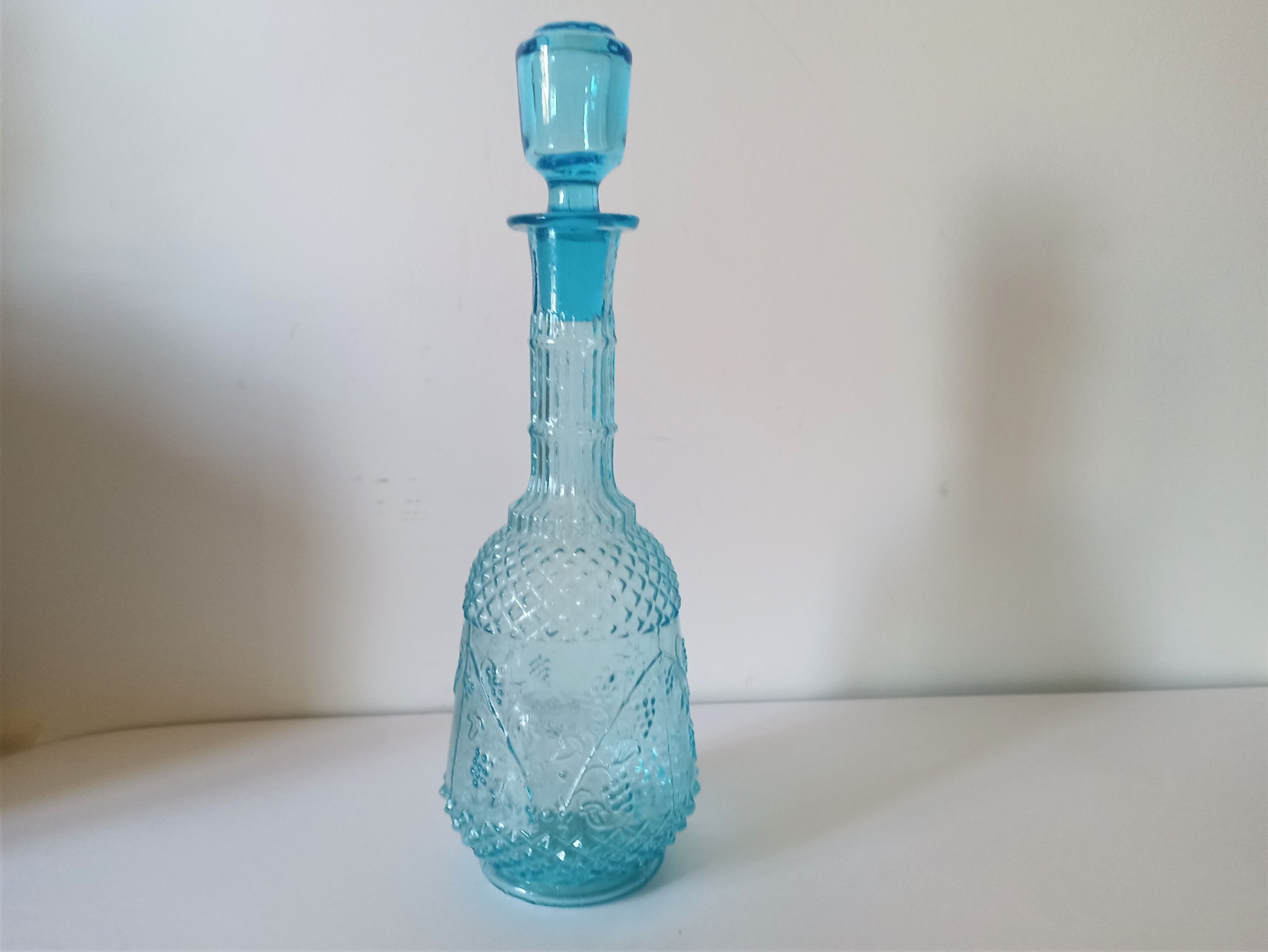 Old turquoise blue molded glass liqueur bottle and its cap