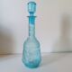 Old turquoise blue molded glass liqueur bottle and its cap