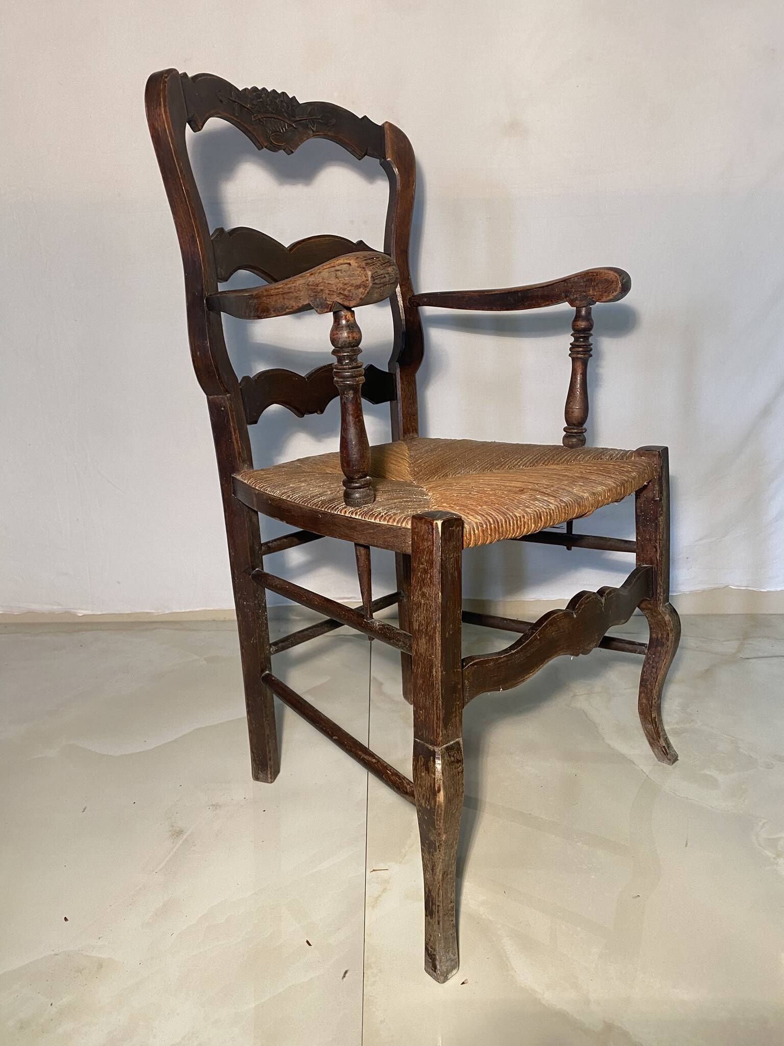 Antique Provencal armchair in carved wood with straw seat
