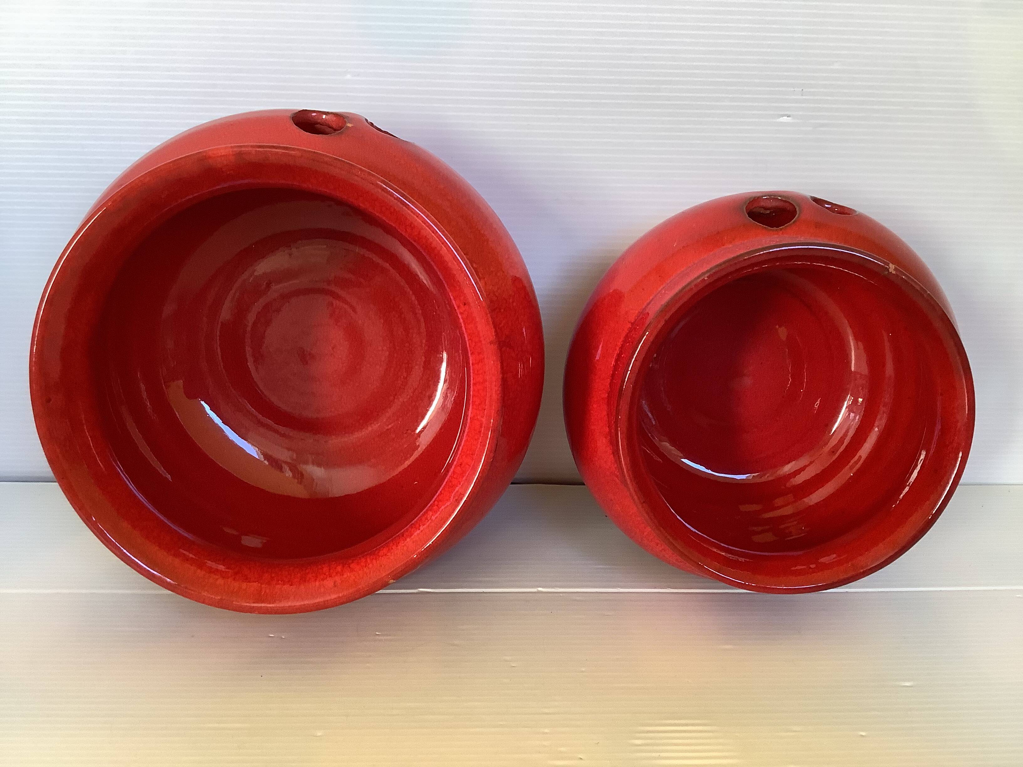 Pair of red Scandinavian candle holders.