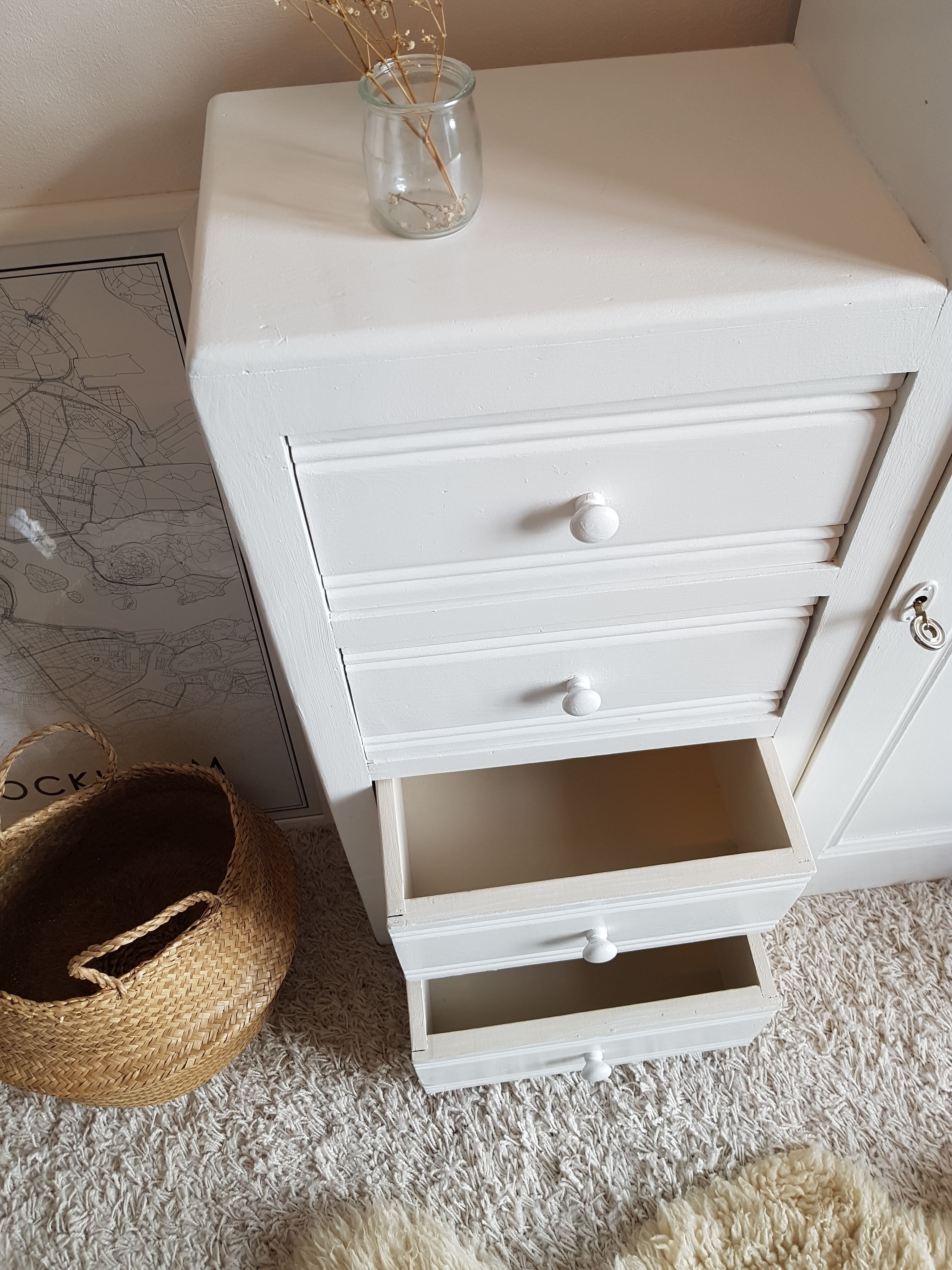 Old white asymmetrical chest of drawers