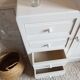 Old white asymmetrical chest of drawers
