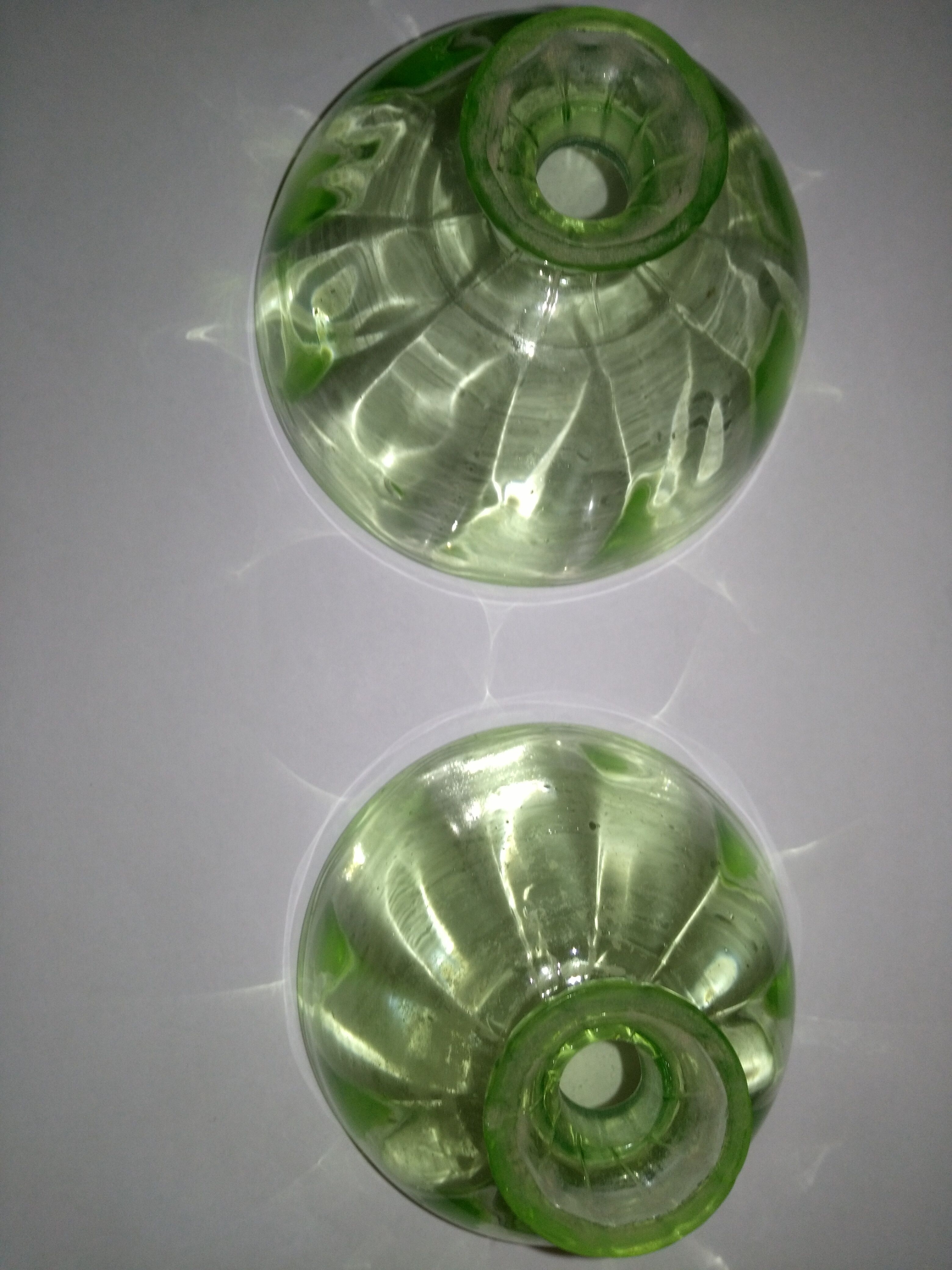 Two bottles in glass, (certainly), surroundings of the 1930s