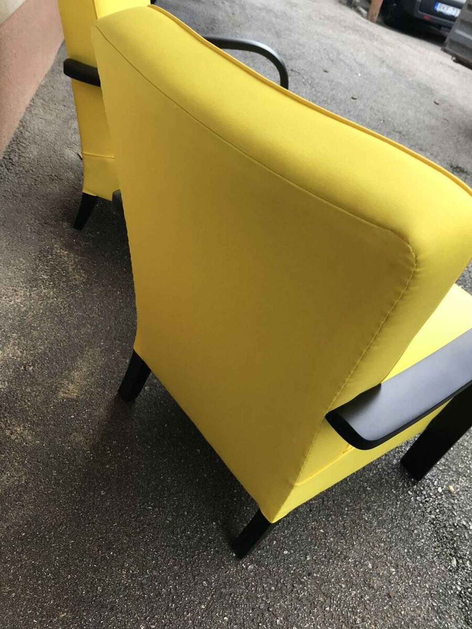 Pair of yellow Art Deco armchairs in cotton and wood, black frame, 1920s.