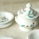 Tableware set in earthenware with floral decoration.