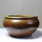 Vintage glazed stoneware bowl or planter in rustic wabi-sabi style.