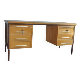 Mid-century Hungarian brown wooden desk with symmetrical drawers and white handles.