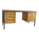 Mid-century Hungarian brown wooden desk with symmetrical drawers and white handles.