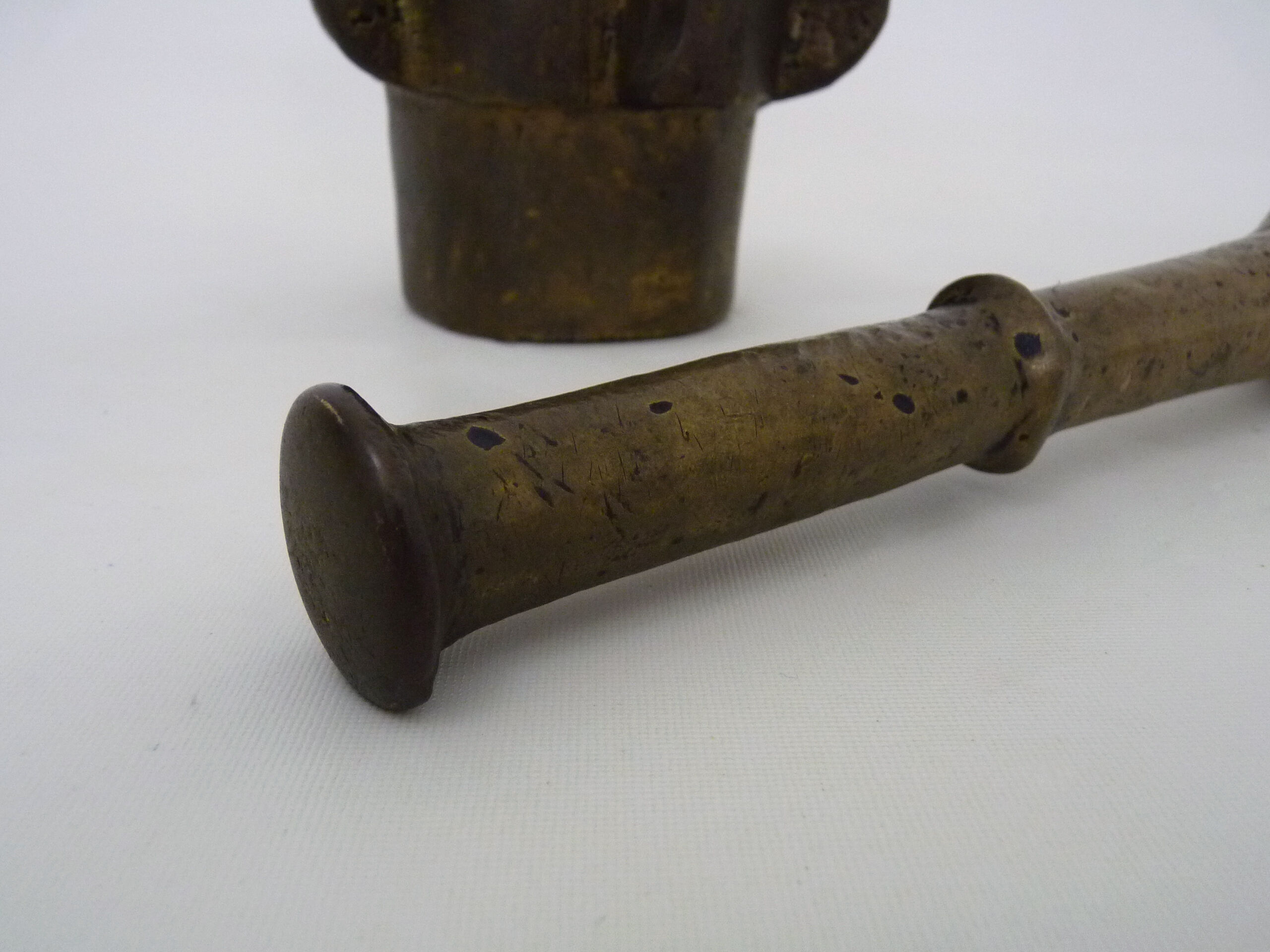 Old apothecary mortar with fins and its bronze pestle