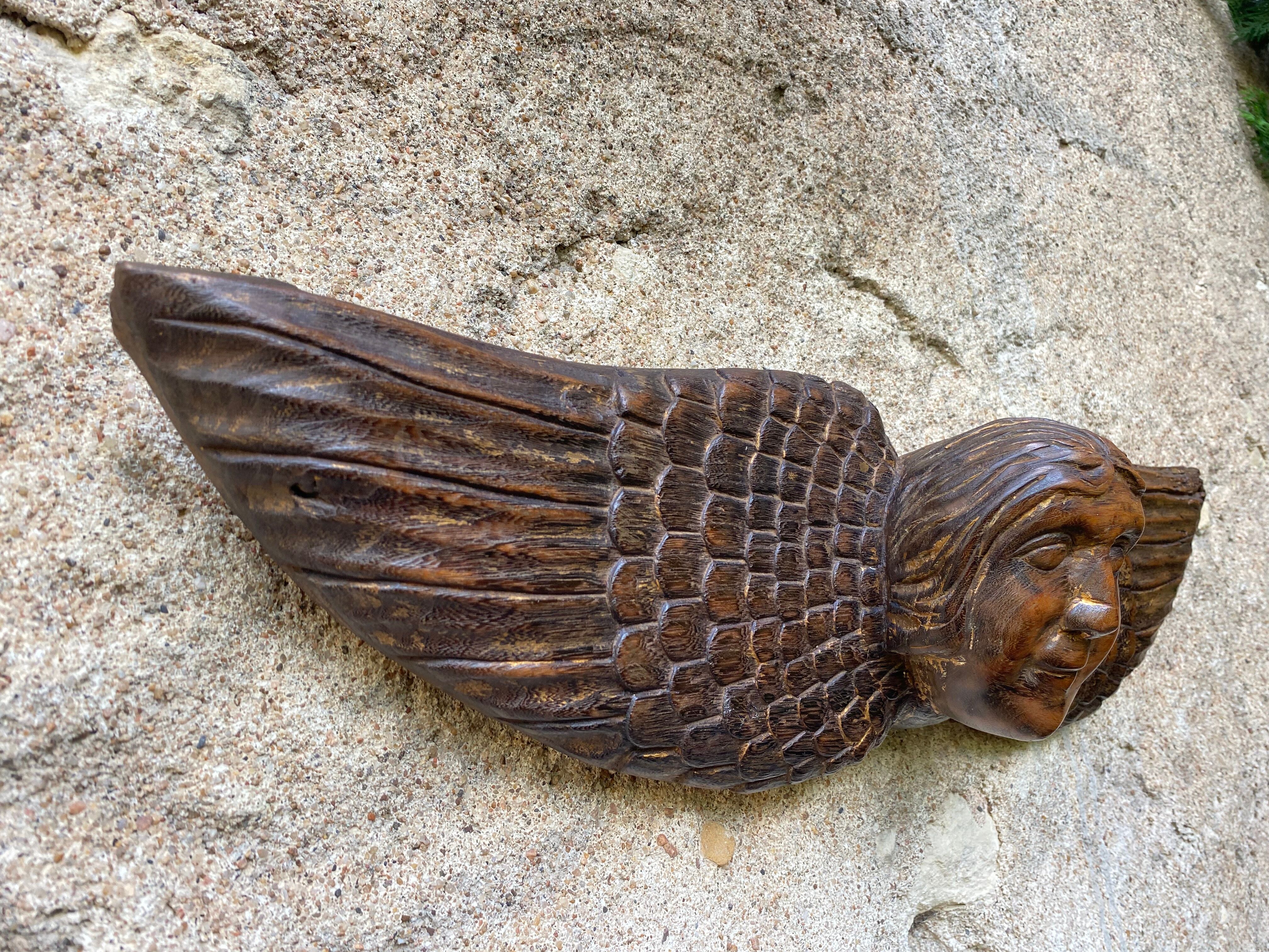 Carved wooden angel head