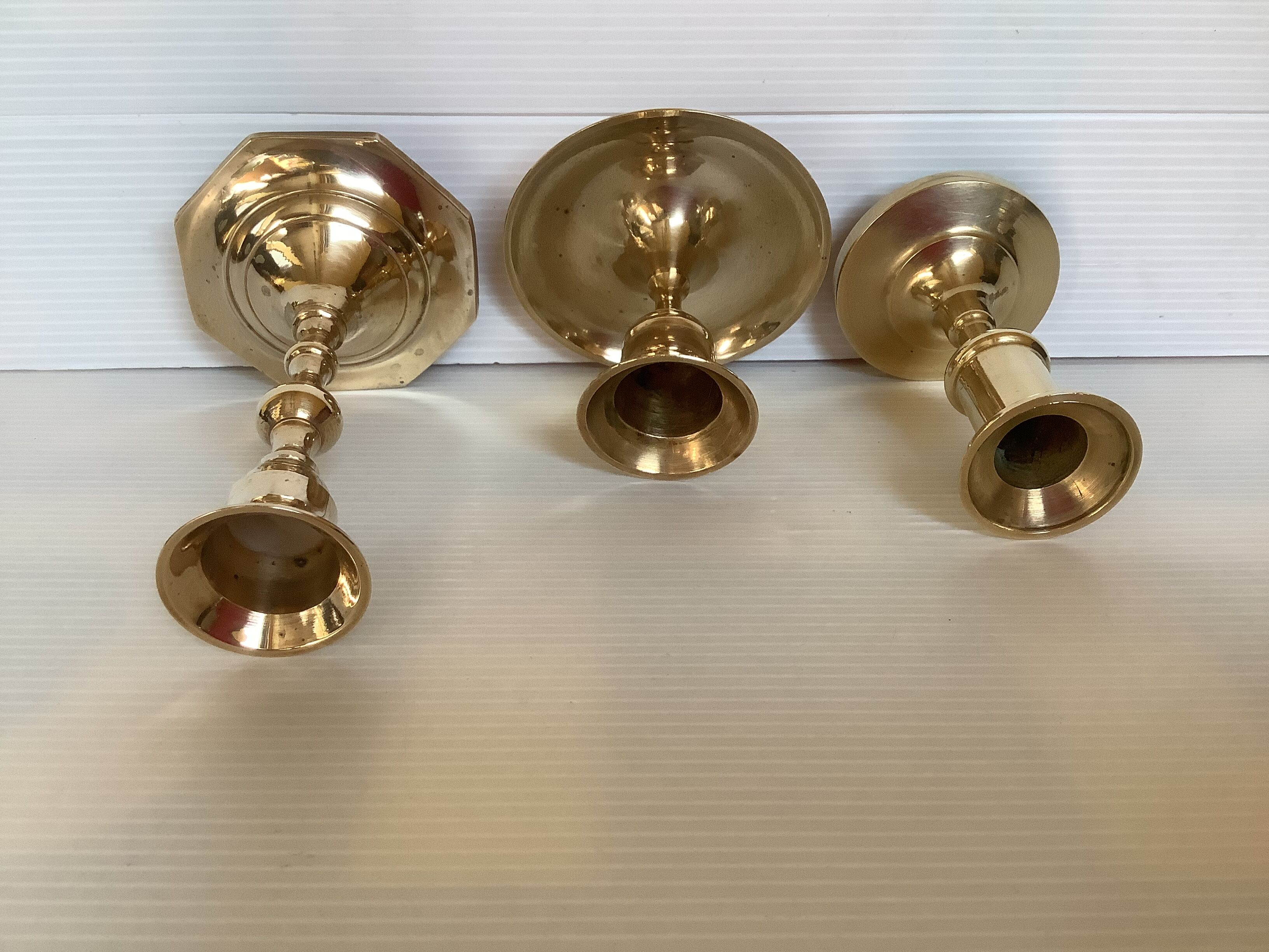 Trio of brass candle holders