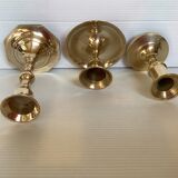 Trio of brass candle holders