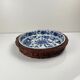Set of 6 ceramic presentation plates in white and blue, floral pattern with woven wicker frame, 1970s/80s.