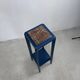 Blue side table with a veined stone top and a low shelf in the Art Deco style.