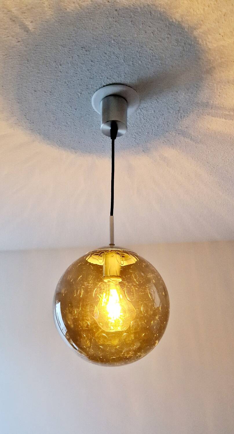 Smoked glass ball pendant light by Raak 1970