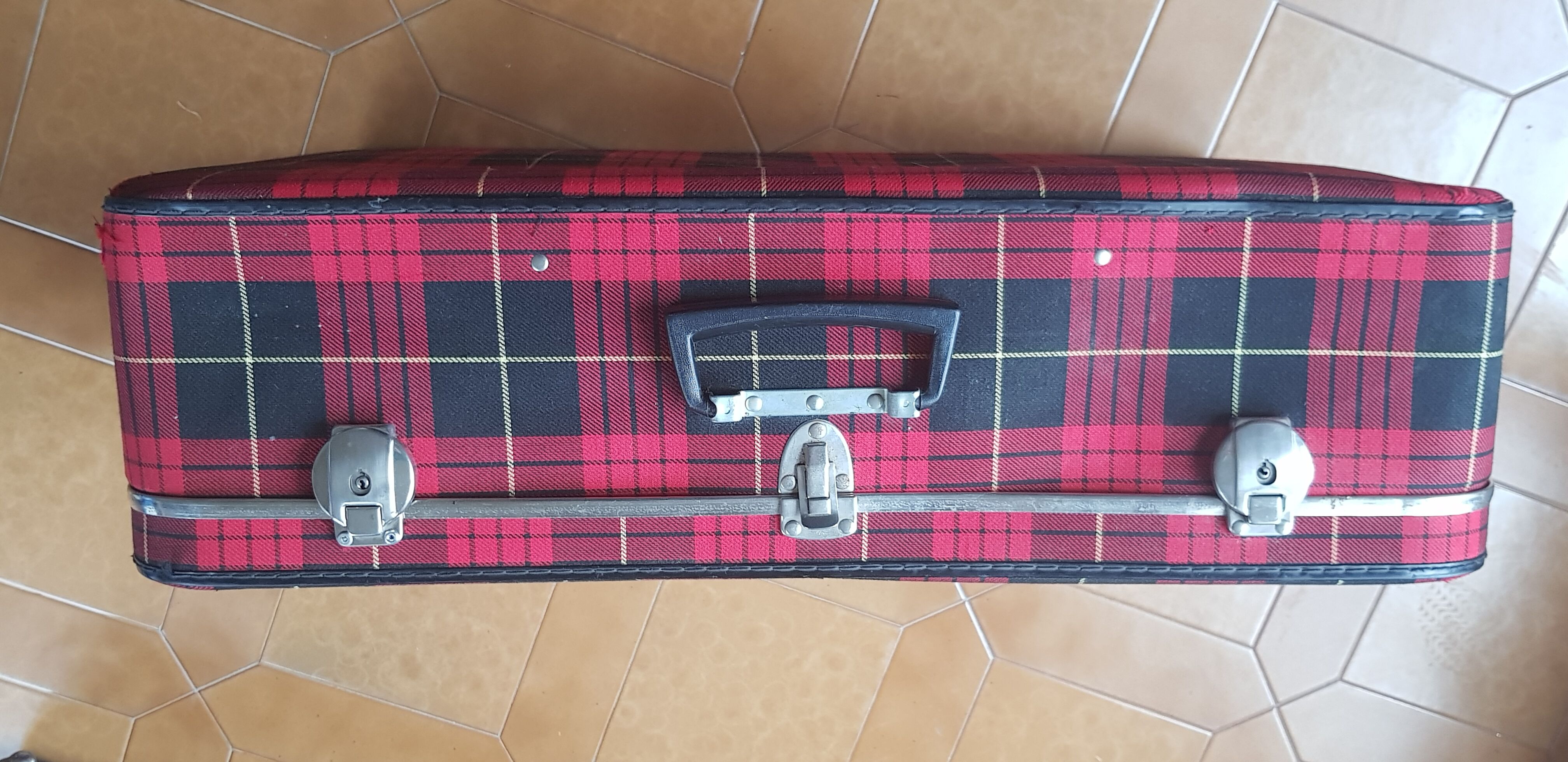 Vintage suitcase covered with scottish fabrics