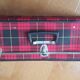 Vintage suitcase covered with scottish fabrics
