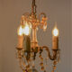 Small vintage brass chandelier with amber crystal pendants.