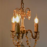 Small vintage brass chandelier with amber crystal pendants.
