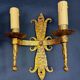Pair of electrified golden wrought iron gothic wall sconces.