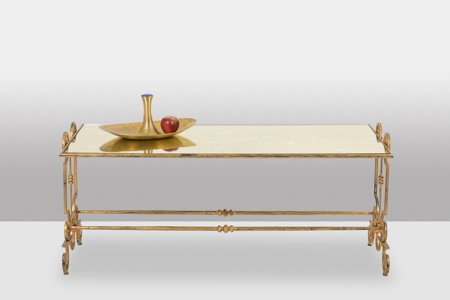 Gold wrought iron coffee table with a mirrored glass top. 1970s.