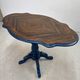 Wooden gueridon with a violin-shaped top in Rio rosewood, central base resting on four legs, reinterpreted in Baltic blue.