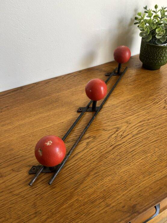 Coat rack with 3 red wooden balls