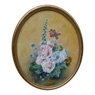 Still life of flowers in a golden oval frame
