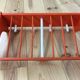 Space age wall coat rack, orange wood, with its shelf from the 1970s.