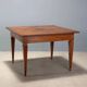 Antique Directoire table in walnut and cherry, Italy, 19th century.