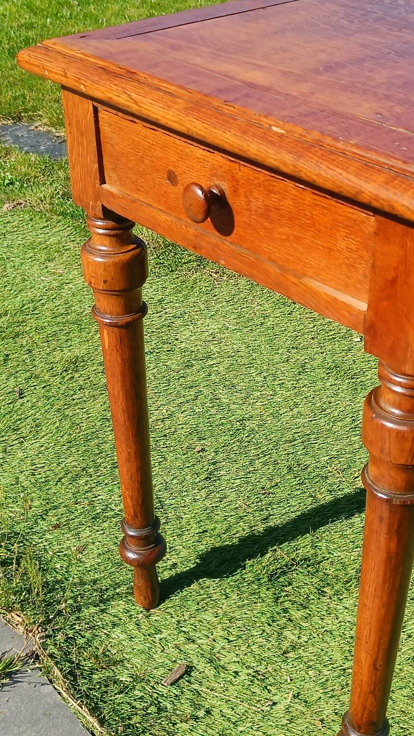 Antique solid wood table with a through drawer.
