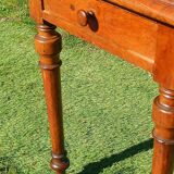 Antique solid wood table with a through drawer.