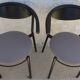 4 gondola-style chairs with a sturdy metal frame and faux leather.